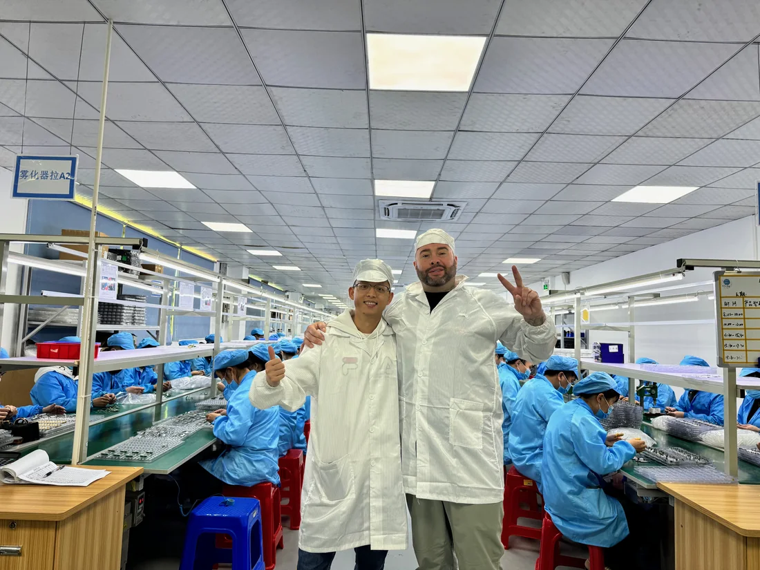 John Dawson Jr. in a cleanroom coat on the atomizer assembly line at a partner factory in Shenzhen