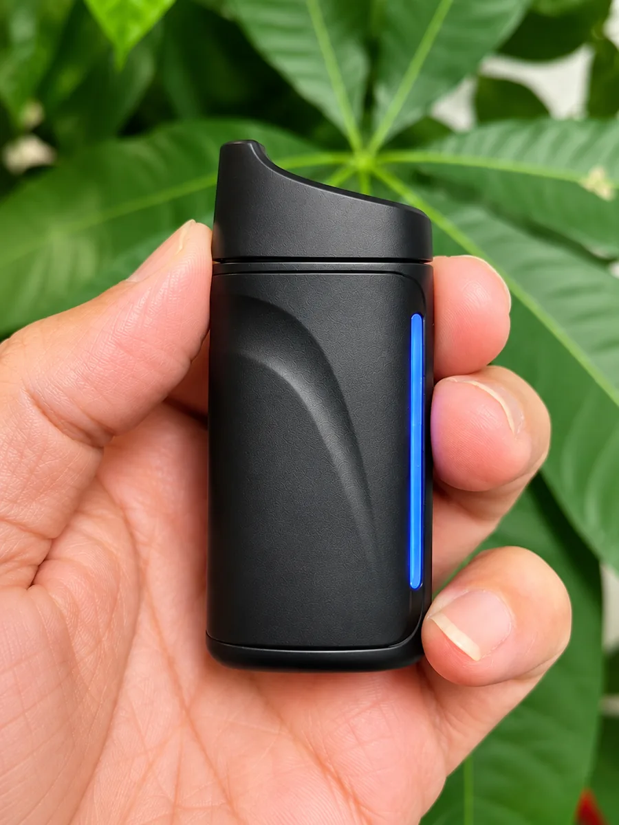 Omega Elite held in a hand at an angle, showing the tapered mouthpiece and contoured body