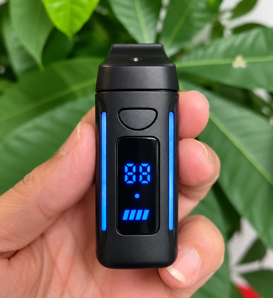 Omega Elite held in a hand, front view showing the temperature display and twin illuminated light bars